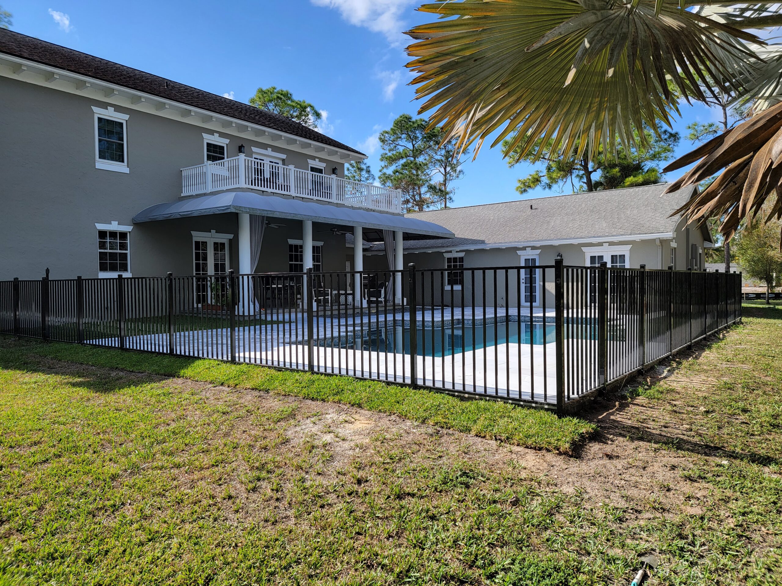 Black aluminum pool barrier fence installation by Pick-It Fence Company, Palm Beach County FL